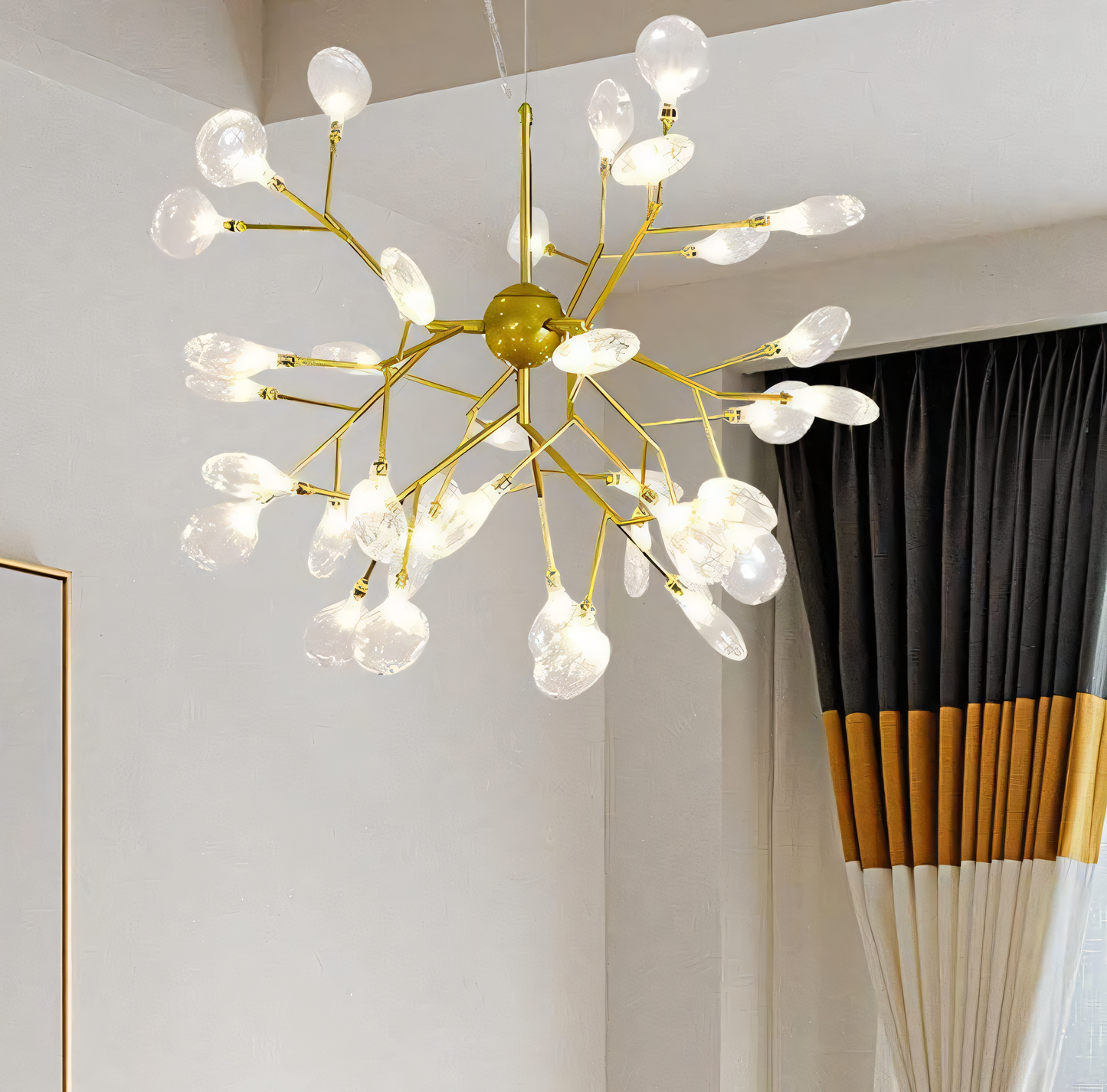 A close-up of the Blaze Round Chandelier reveals its intricate gold frame and 27 LED branches.