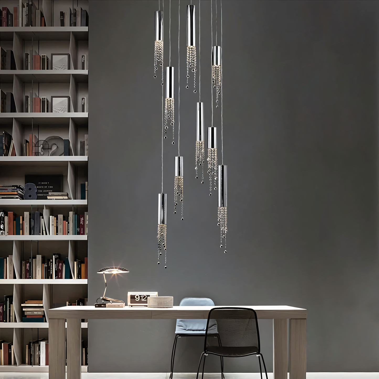 A modern silver chandelier with a geometric design hangs from a living room ceiling.