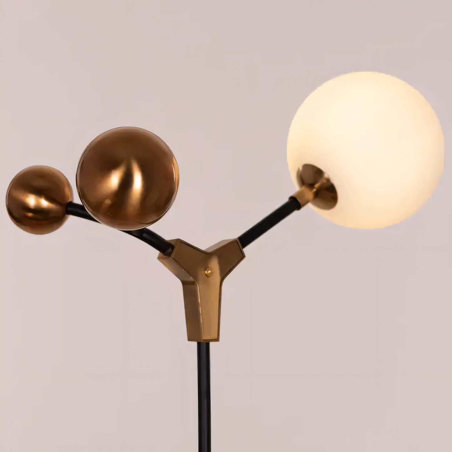 Detailed view of the Owe & Awe Floor Lamp's matte black metal body and frosted glass shades