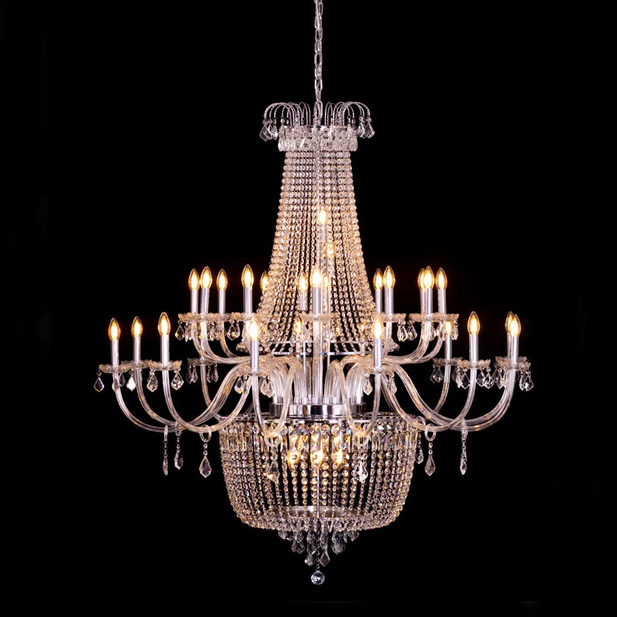 Large chrome crystal chandelier with letter-shaped elements, hanging in a luxurious living room