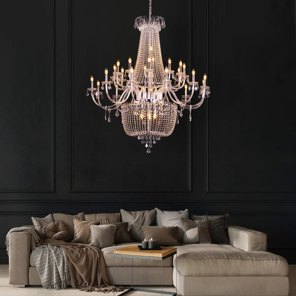 Large chrome crystal chandelier with letter-shaped elements, hanging in a luxurious living room
