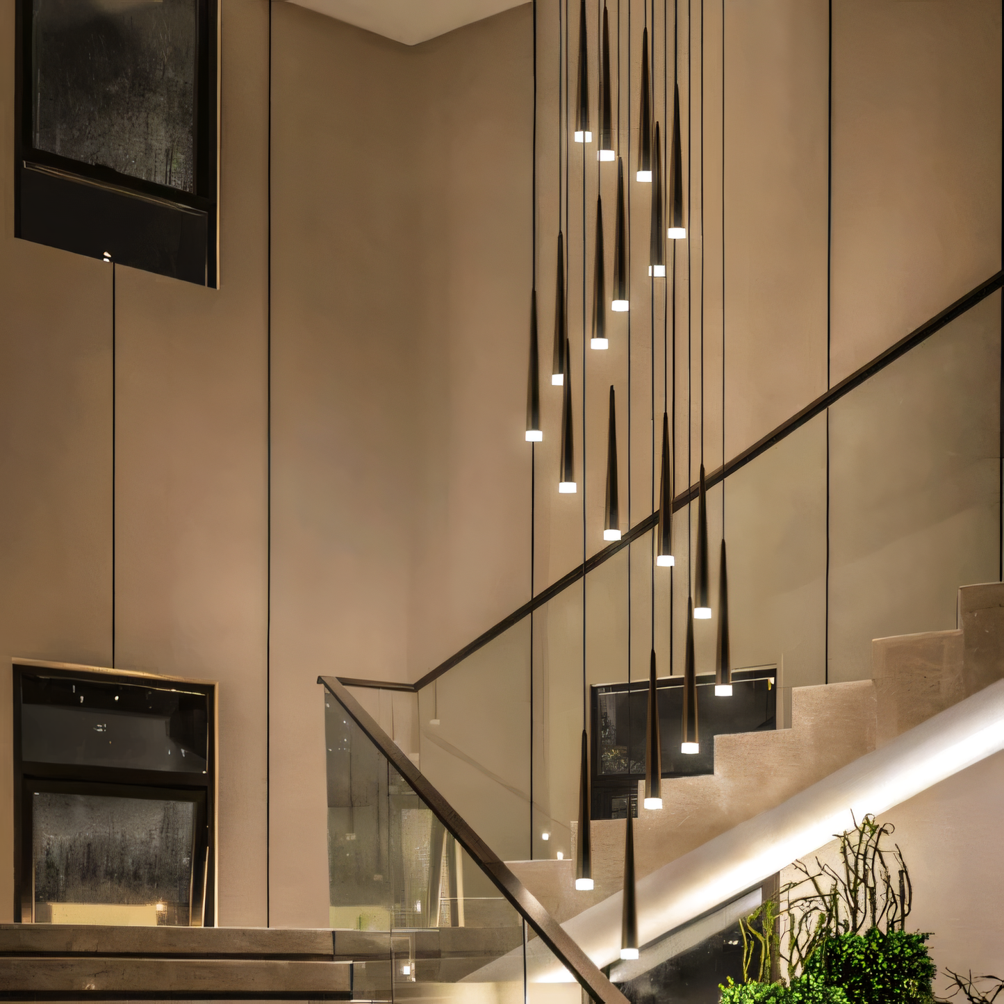 A close-up of the Pluviam Sense Long Chandelier reveals its cascading crystal design and gold finish.