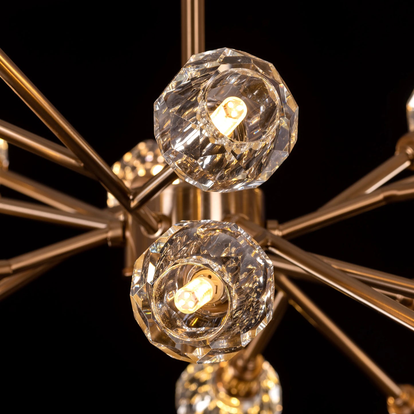 Queen's Necklace medium gold and crystal chandelier illuminating an elegant dining room with its warm, sparkling glow