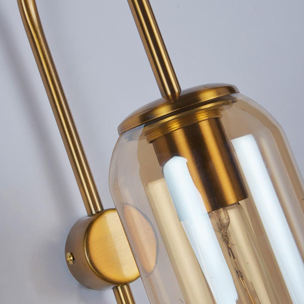 Ancestral wall beacon, gold metal and glass, echoes of heritage.