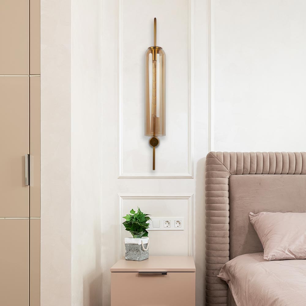 Gold and glass wall fixture, flickering flames, echoes of tradition.