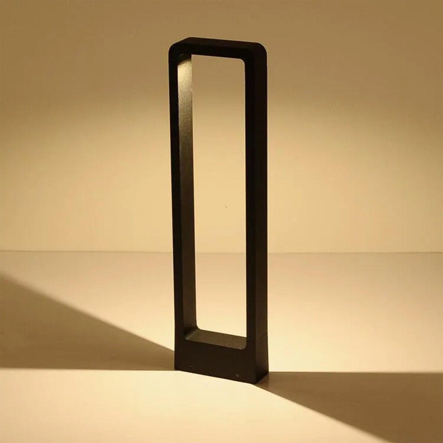 Elegant bollard light illuminating a garden pathway