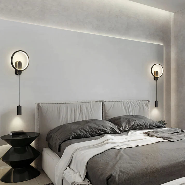 Sleek modern wall light illuminating a contemporary living room, casting a warm glow on a textured accent wall