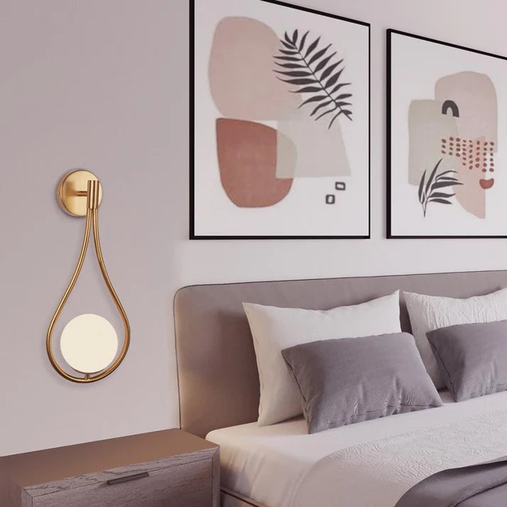 Cozy studio apartment featuring sleek, minimalist wall sconces providing ambient lighting, and an adjustable reading light near a compact workspace, demonstrating effective use of modern wall lights in a small space