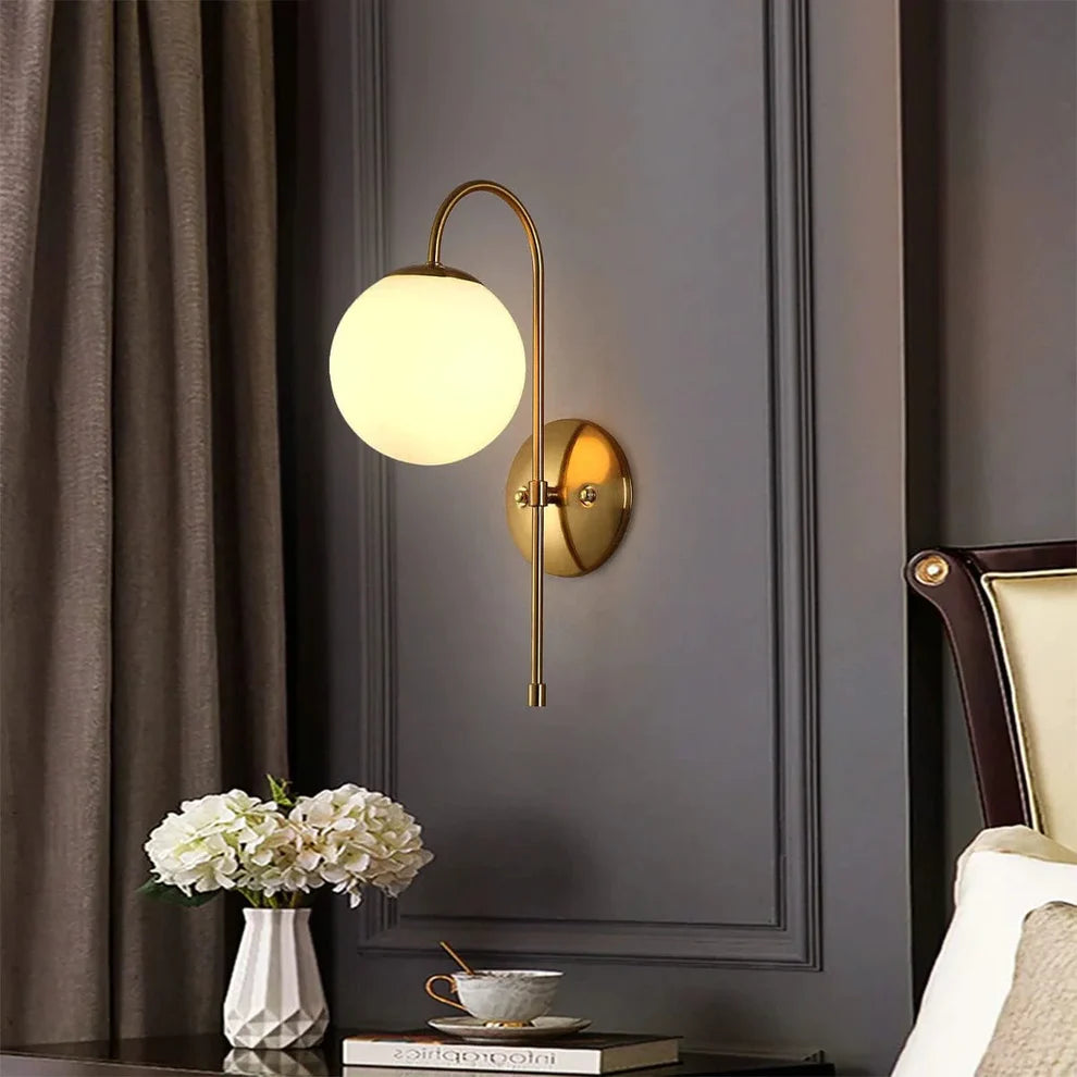 Elegant brass statement wall lights highlighting a textured accent wall in a modern living room