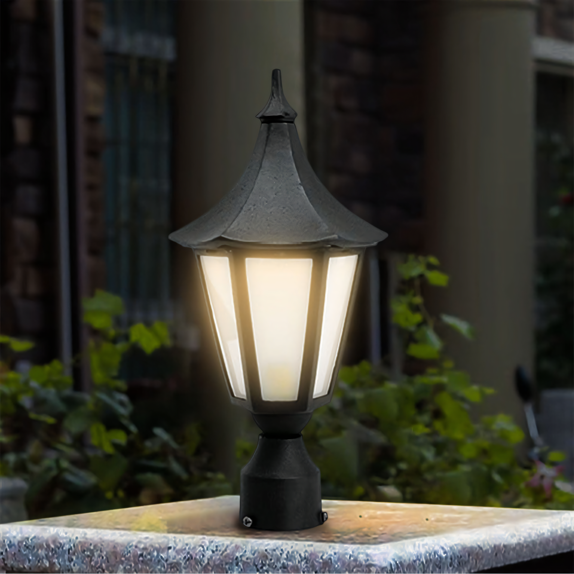 Warm LED illumination of the Madrid Gate Light against a backdrop of lush foliage