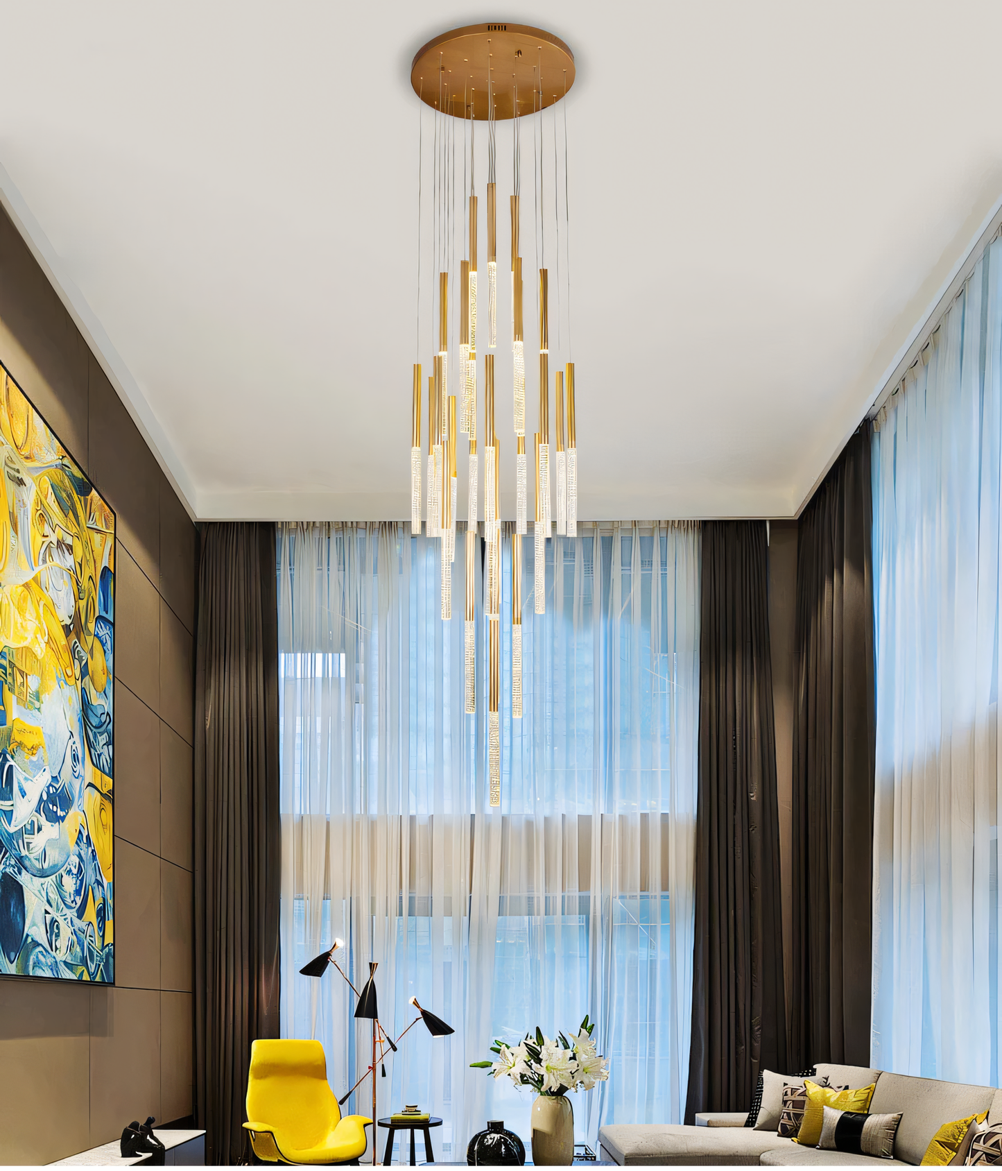 The Blaze Round Chandelier, a forest-inspired centerpiece, hangs above a dining table in a modern home. The chandelier's warm light fills the room.