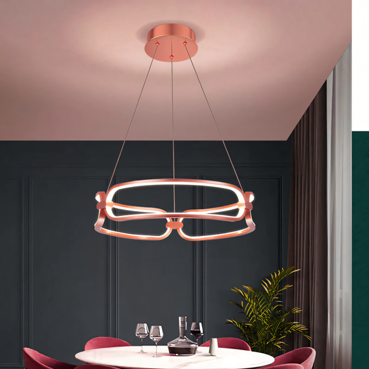 Modern rose gold LED chandelier with a curvy profile creates a warm and inviting glow.