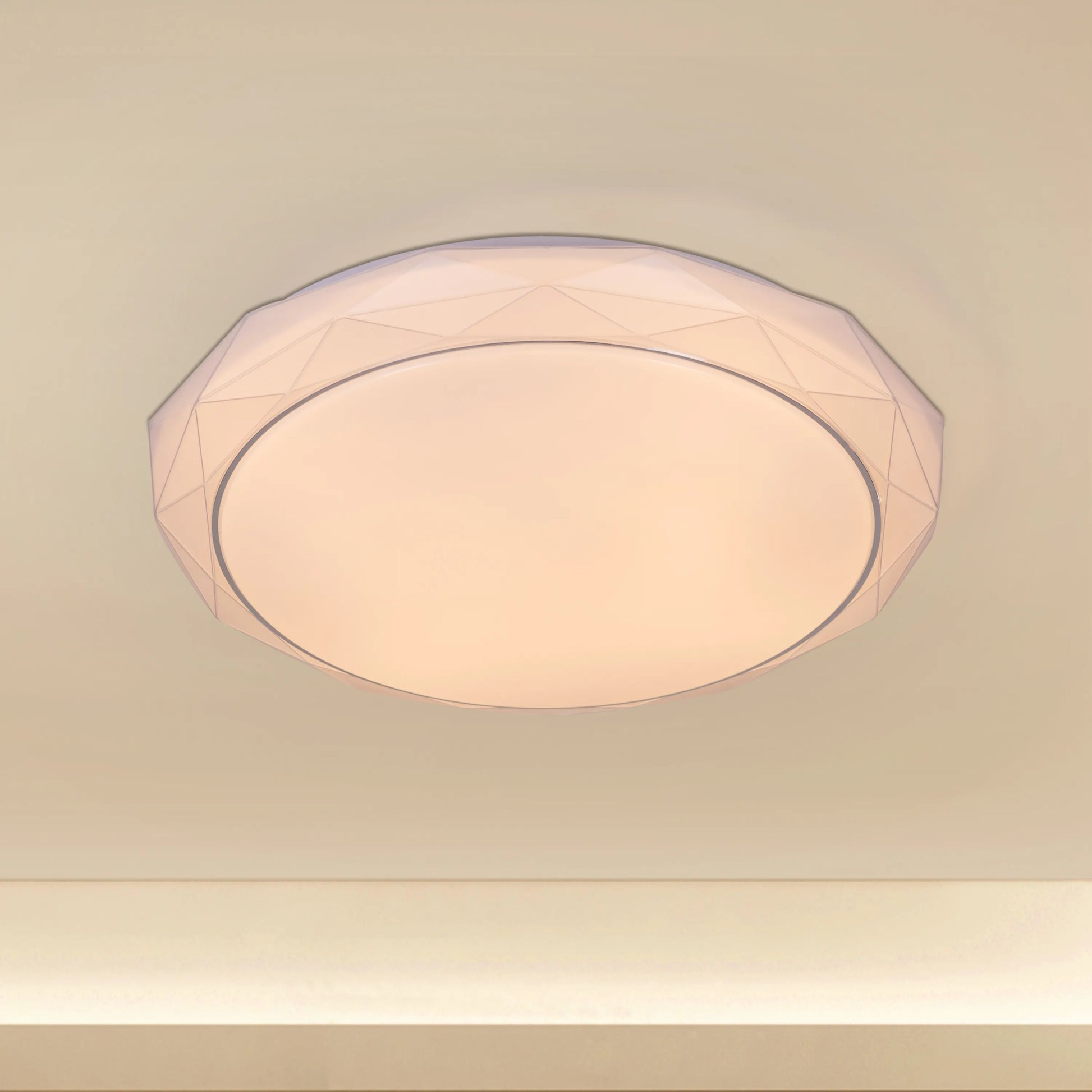 Chrome ceiling light with sleek design and built-in LED lights, displaying warm white illumination