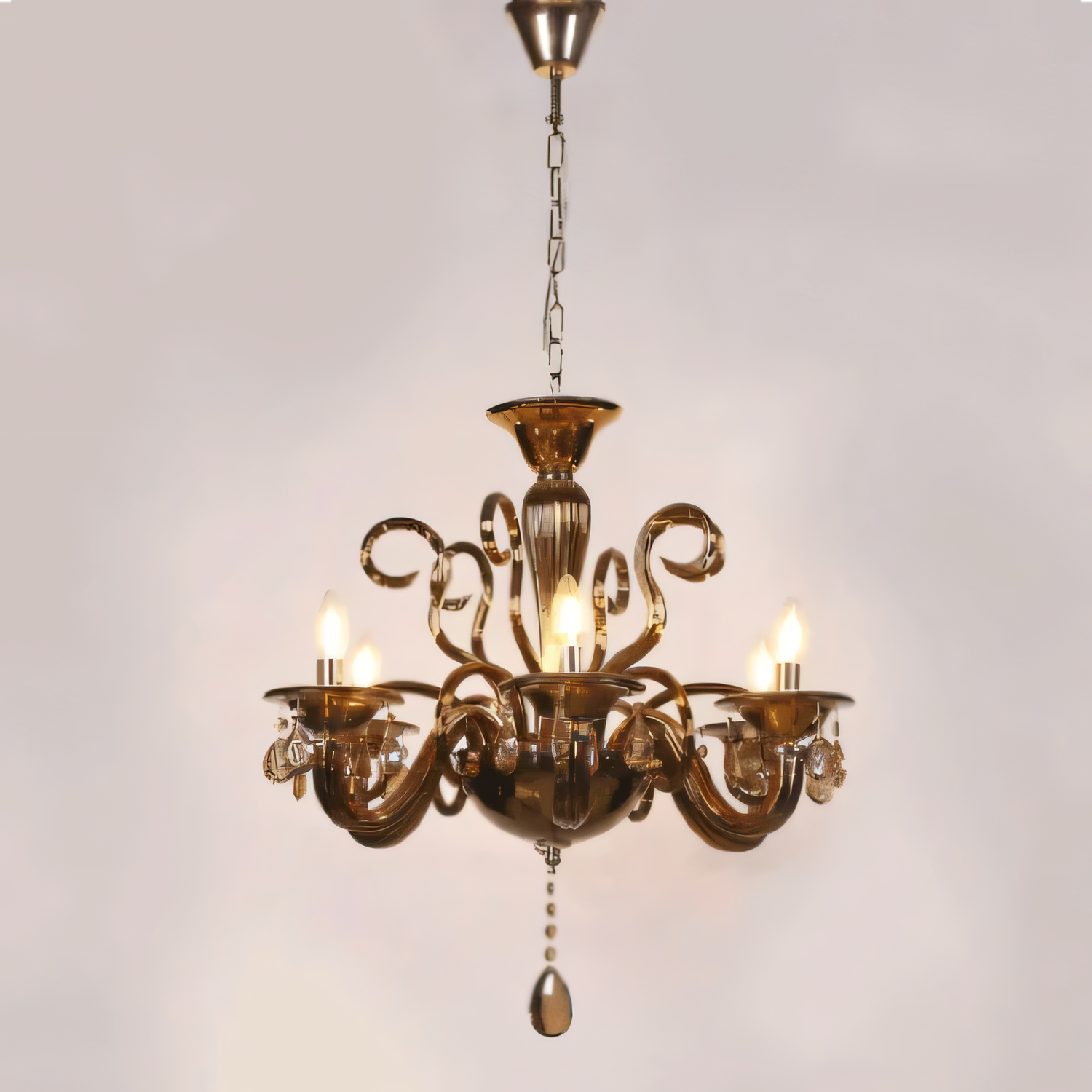 Intricate metalwork and cascading crystal droplets of the chandelier