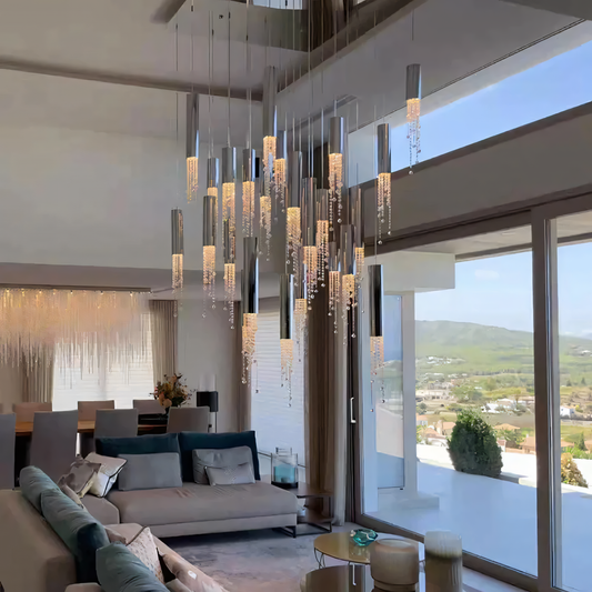 A modern silver chandelier with a geometric design hangs from a living room ceiling.