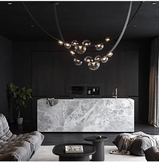 A black metal chandelier with a black leather belt, smoky glass globes, and seven lights hangs from a dining room ceiling. The chandelier casts a warm, inviting glow on the space.