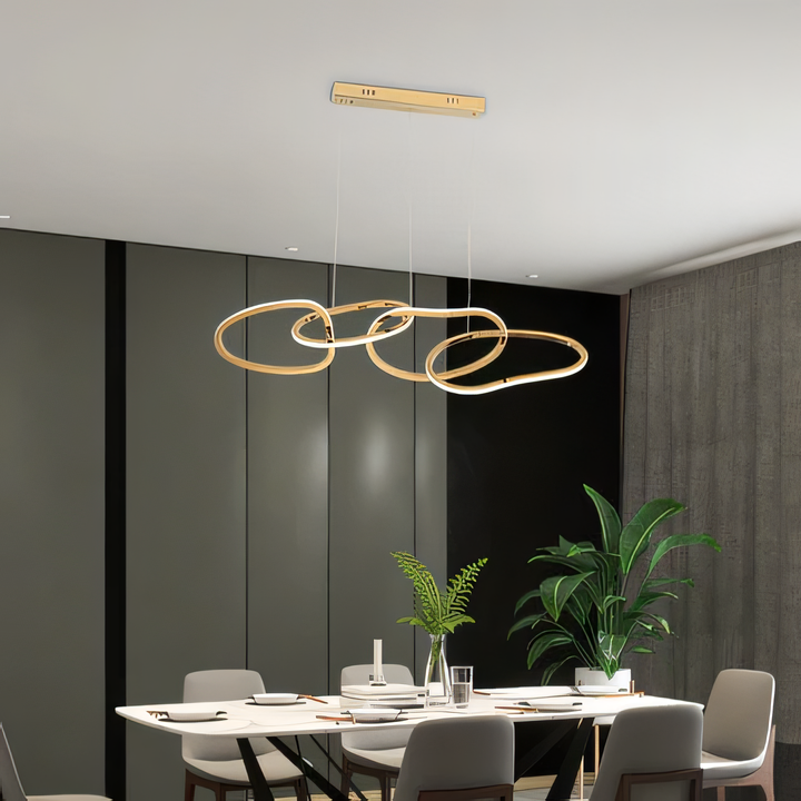 Energy-efficient LED chandelier with a cascading gold ring design, ideal for modern living spaces.