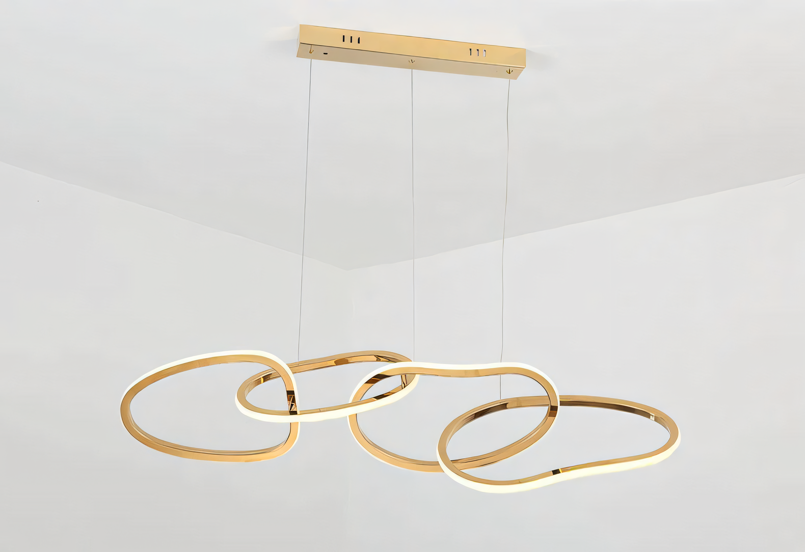 Modern twist on the jhoomar, this 4-ring gold LED chandelier features a cascading design with a warm and inviting glow.