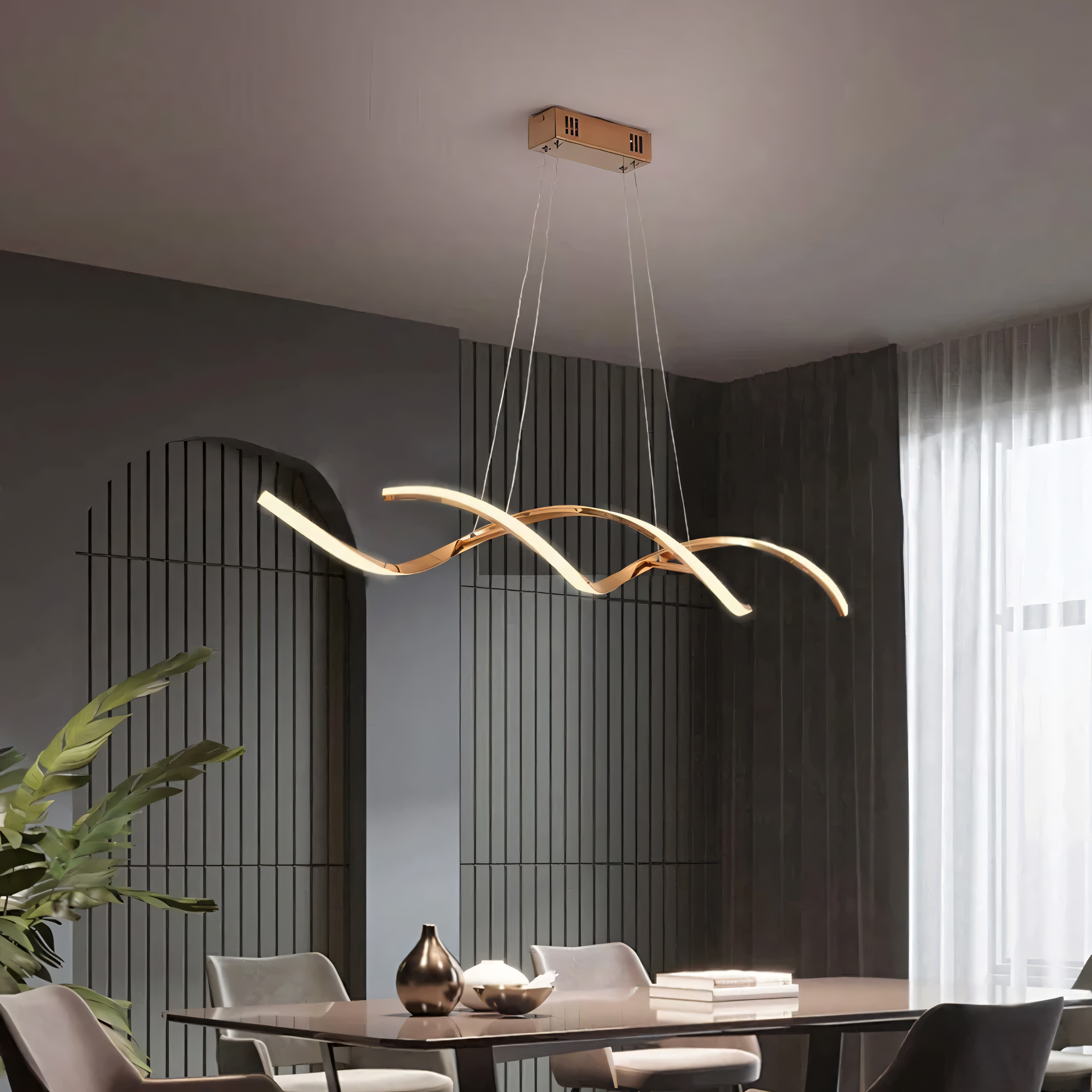 The Swirl Luxe Modern Dining Chandelier adds a touch of modern elegance to a minimalist dining room. The chandelier's warm light creates a dazzling display.