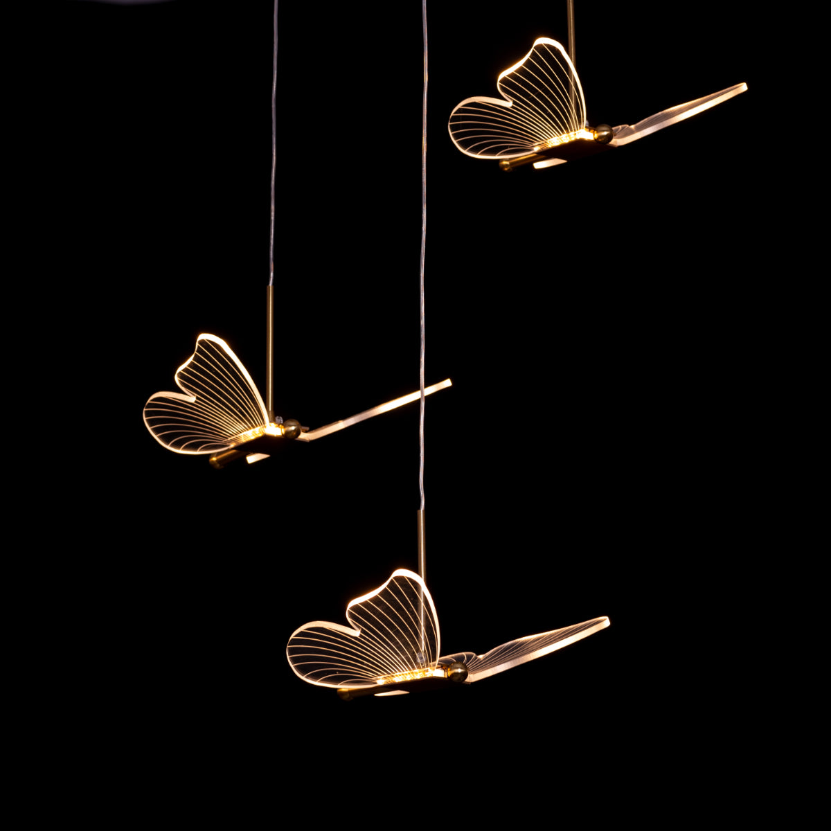 Butterfly Kisses gold chandelier illuminating an elegant living room with soft, warm light