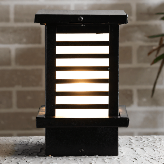 Sleek black metal gate light in a serene, icy landscape