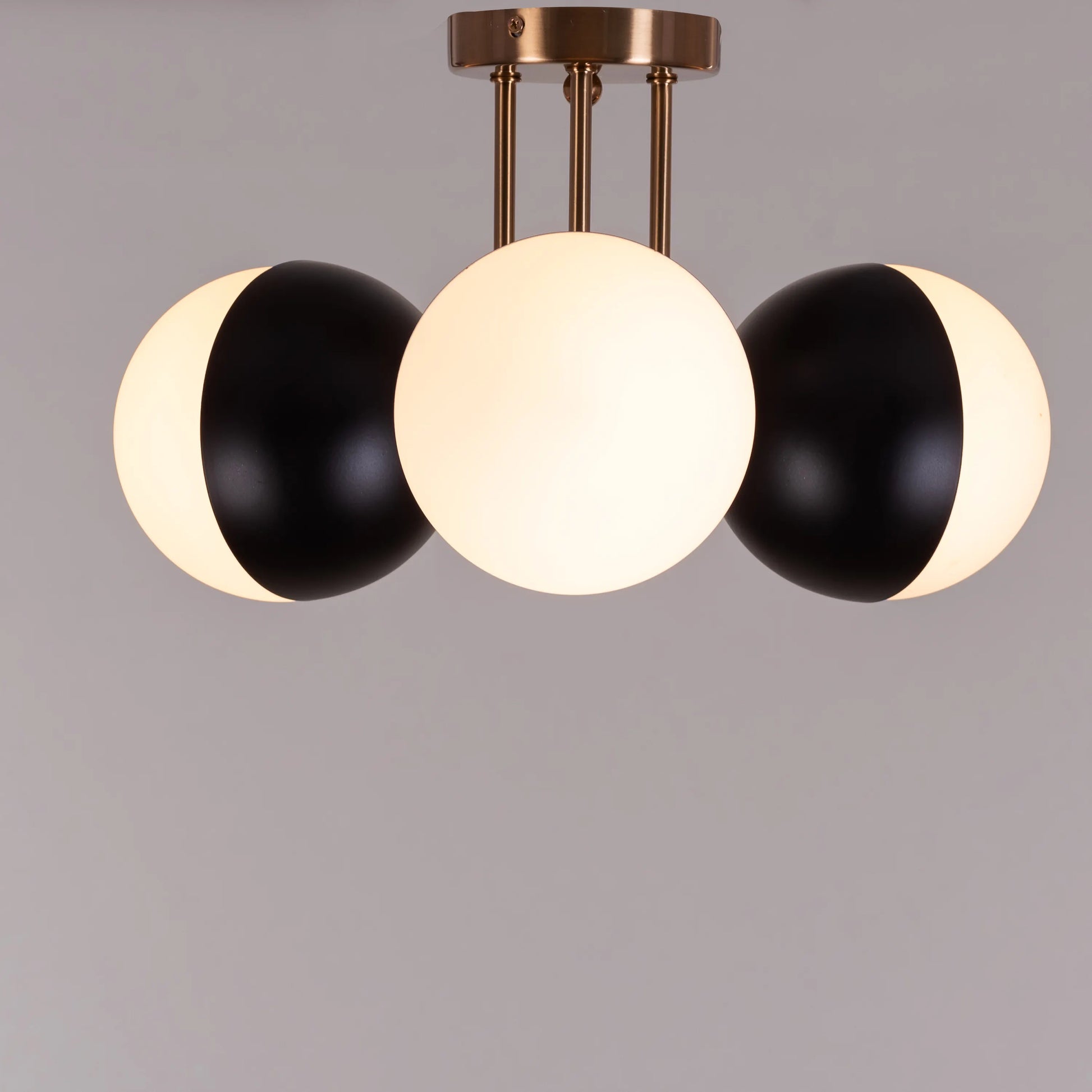 Modern ceiling light with luxurious gold and sleek black elements.