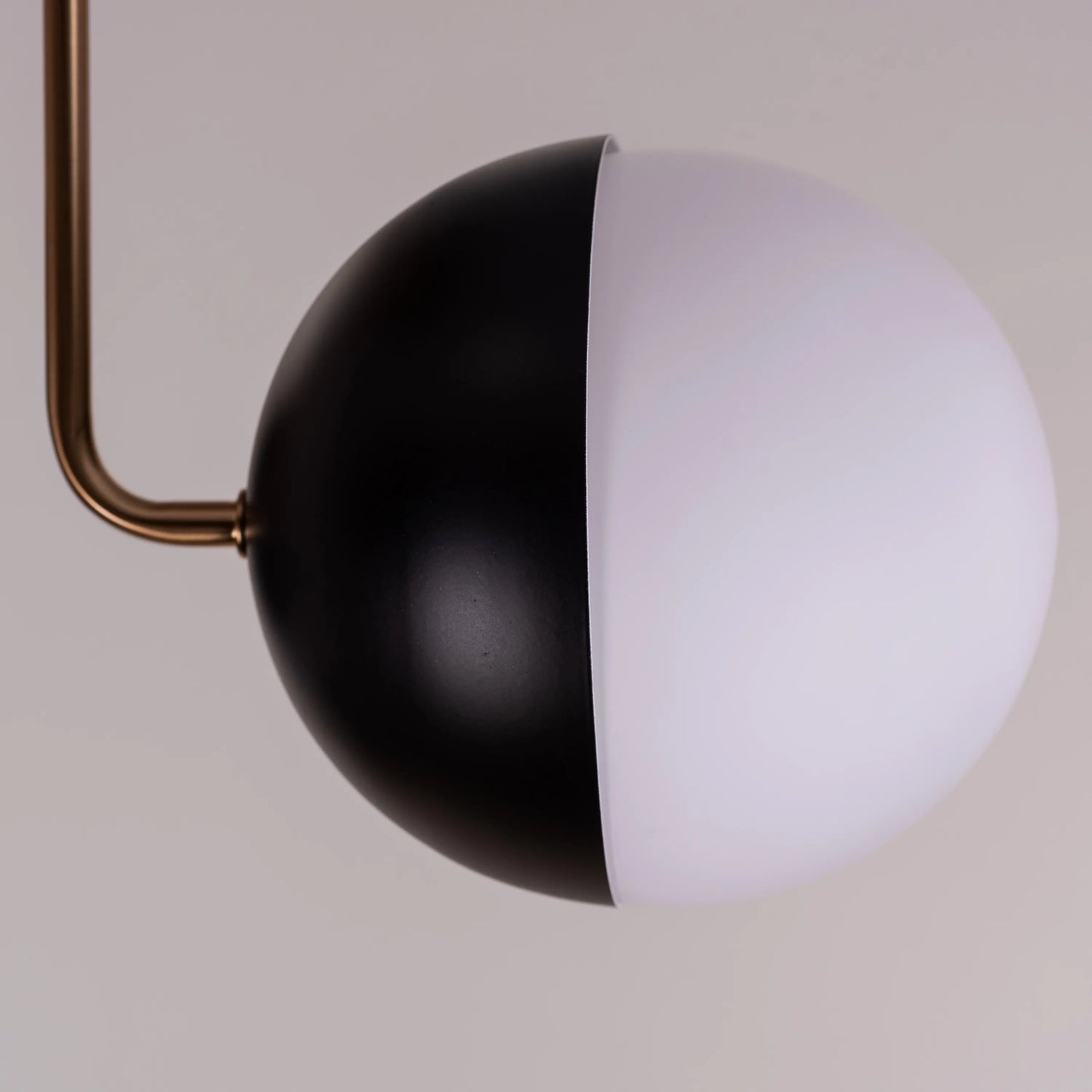 Stylish ceiling light with contemporary gold and black design.