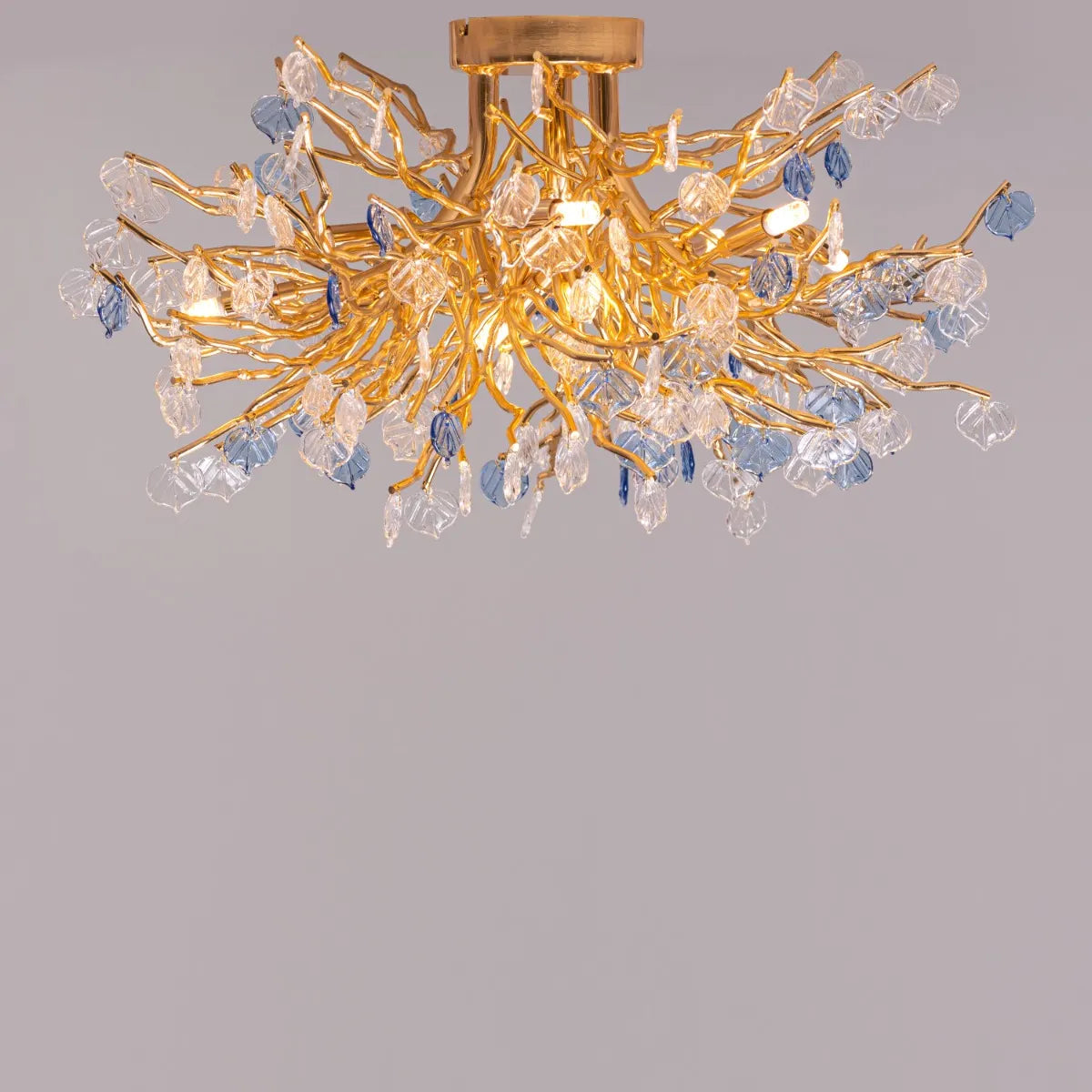 Yacht Life Gold Crystal Ceiling Light illuminating an elegant living room with a warm, luxurious glow