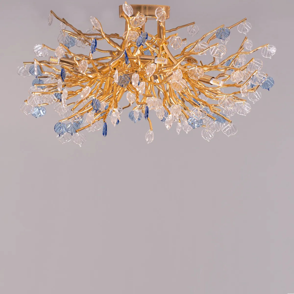 Yacht Life Gold Crystal Ceiling Light illuminating an elegant living room with a warm, luxurious glow