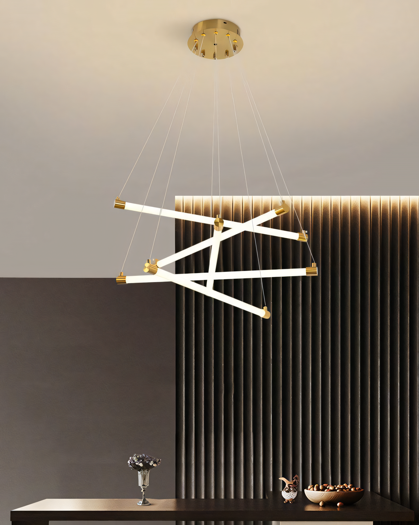 Gold tube LED chandelier with a minimalist design, ideal for adding a touch of modern drama to any space.