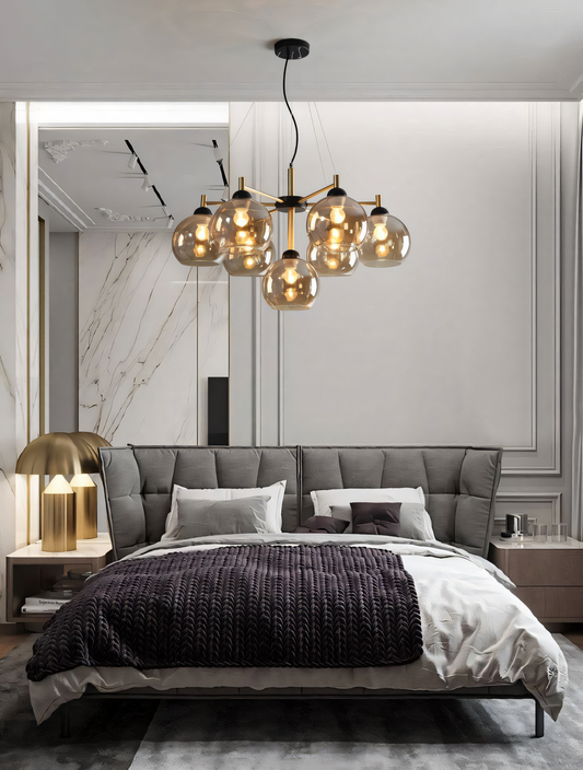 Gold and black modern chandelier with 7 amber glass globes, ideal for living rooms, dining rooms, and more.