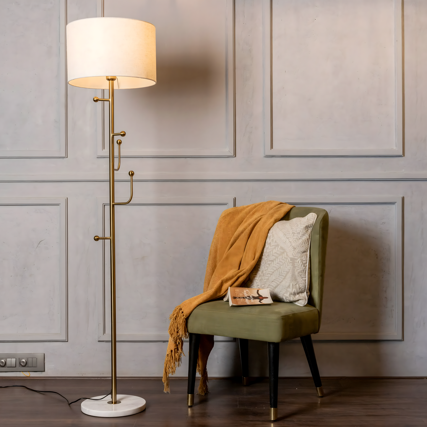 Striking, gold-finished metal frame of the Discovered (Marble) Floor Lamp