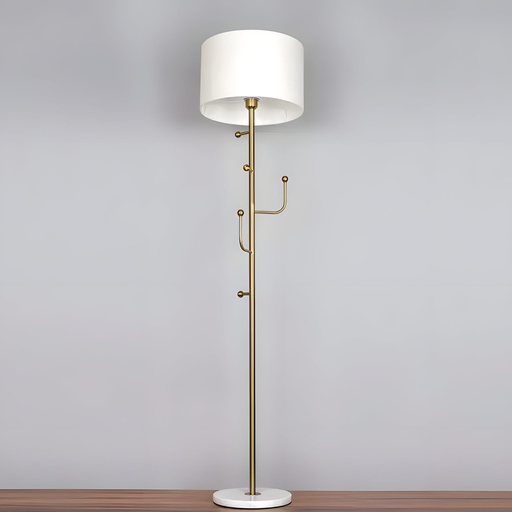 Striking, gold-finished metal frame of the Discovered (Marble) Floor Lamp