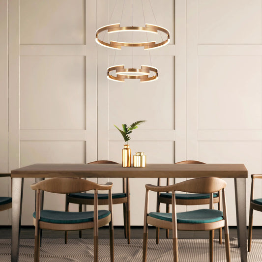 Bring A Friend medium gold chandelier with dimmable LED lights illuminating a modern dining room