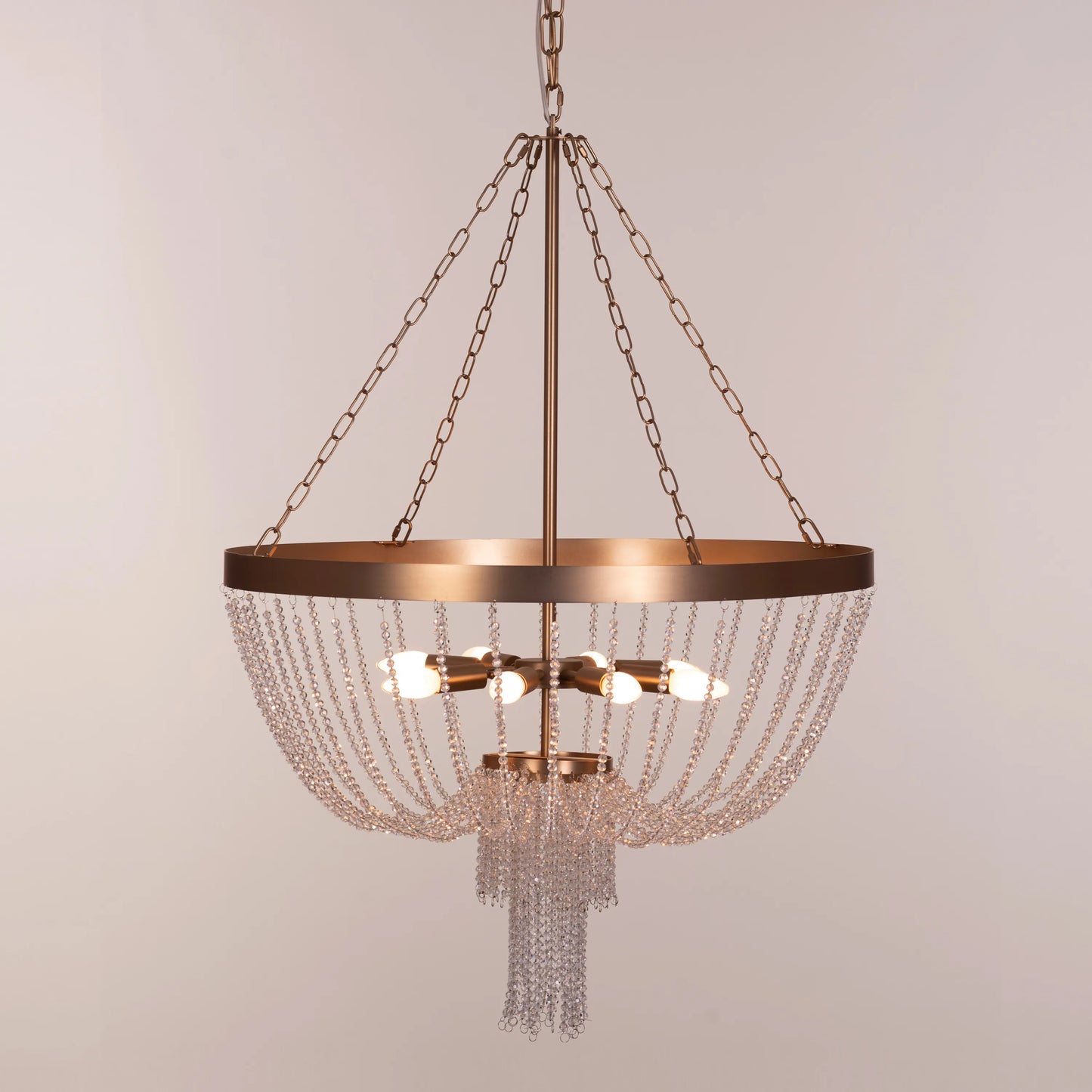 Elegant All That Glows Crystal Chandelier hanging in a modern dining room.