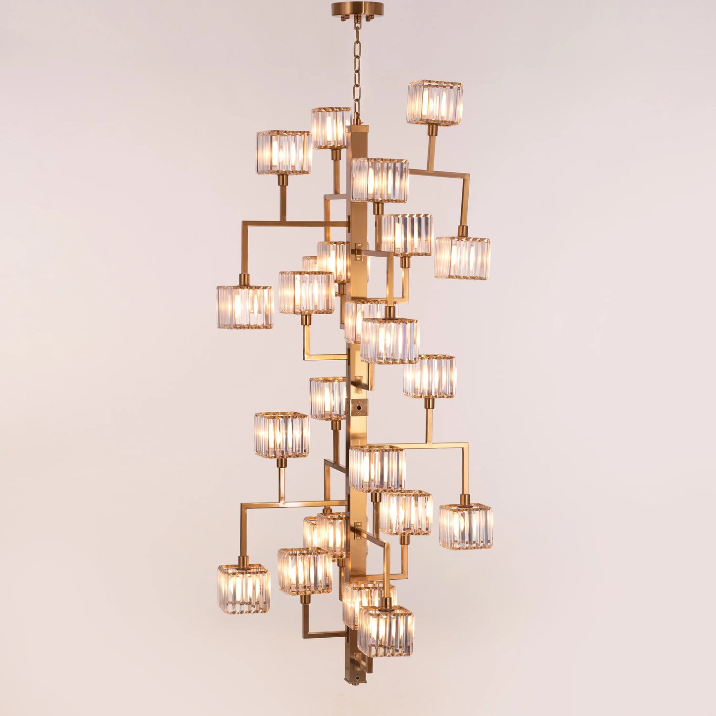 Watch The Throne large vertical gold and crystal chandelier illuminating a grand multi-story foyer with its cascading light