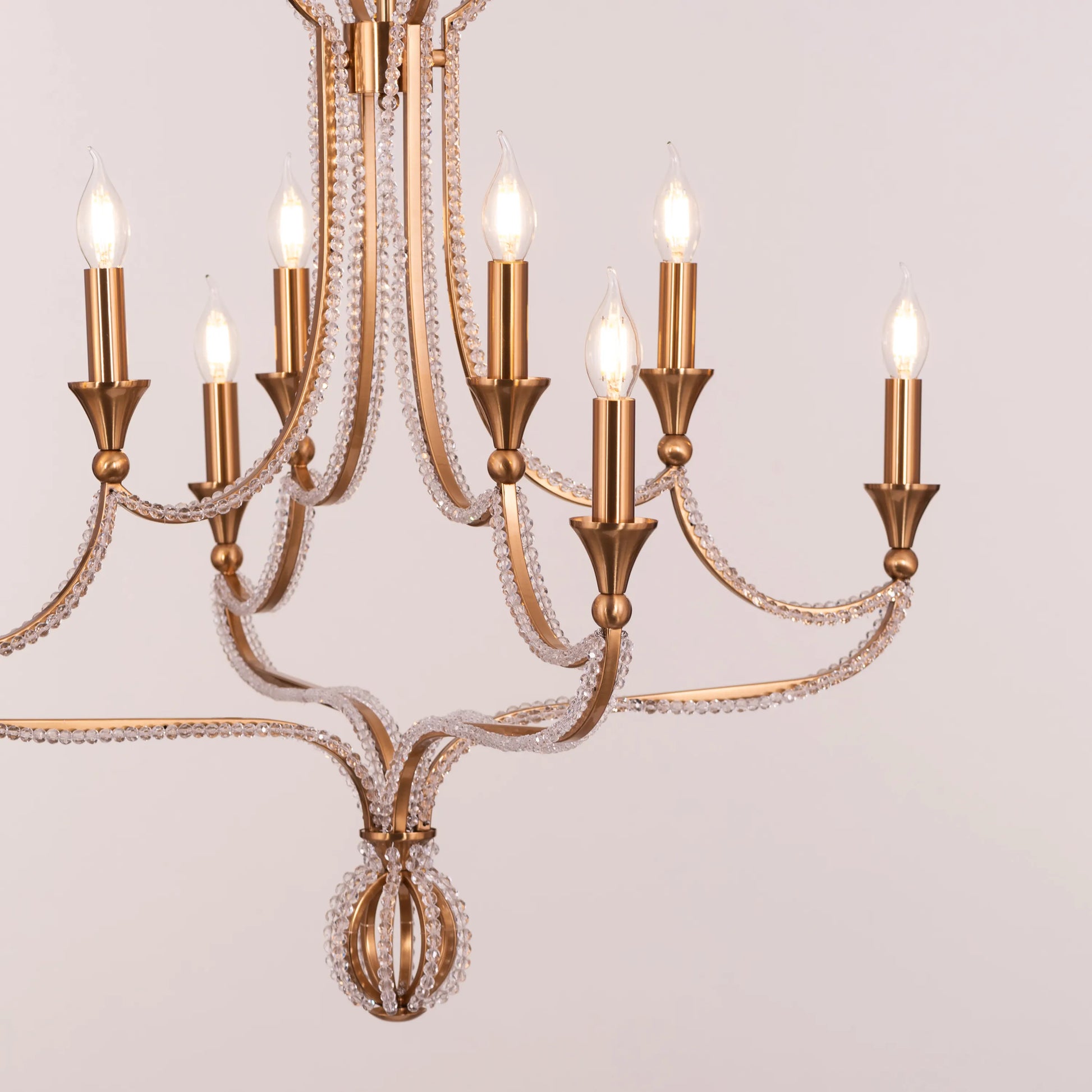 Large gold and crystal chandelier with cascading tiers resembling a fountain of light