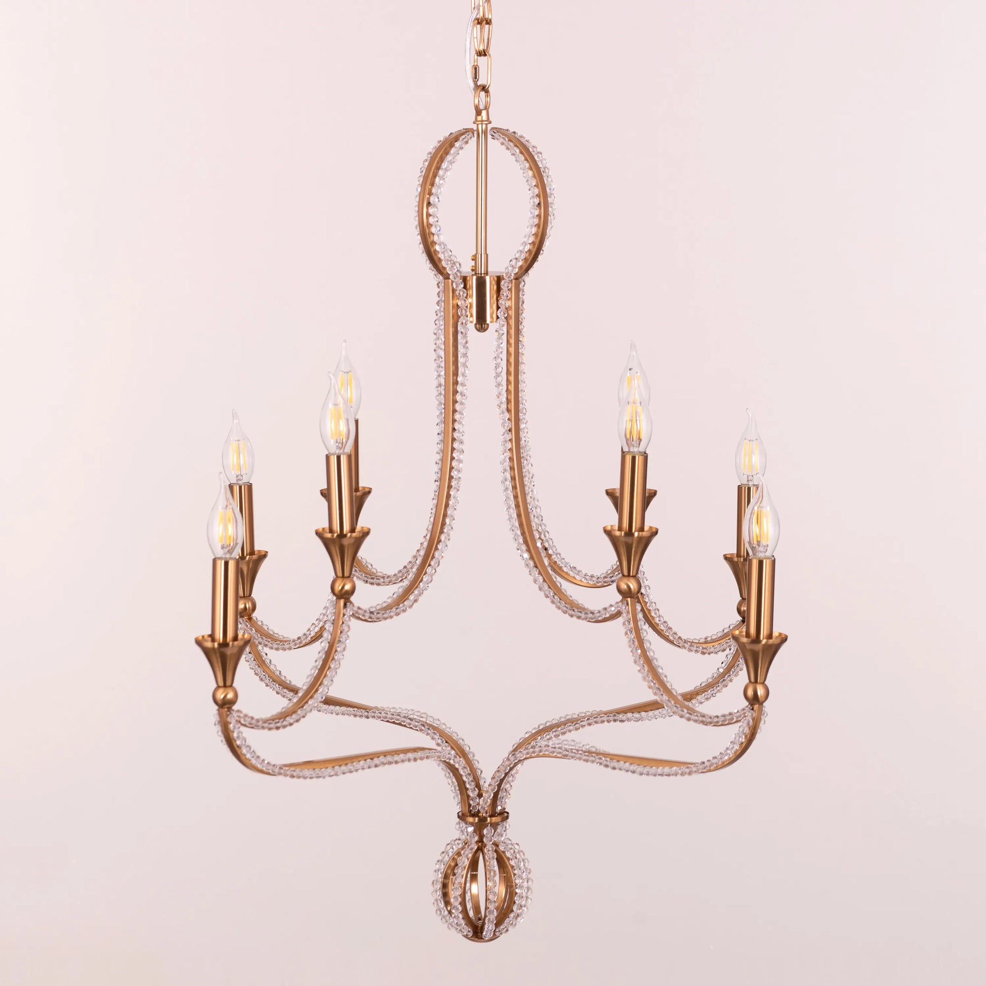 Large gold and crystal chandelier with cascading tiers resembling a fountain of light