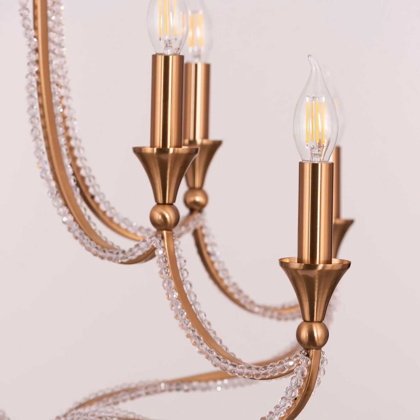 Large gold and crystal chandelier with cascading tiers resembling a fountain of light