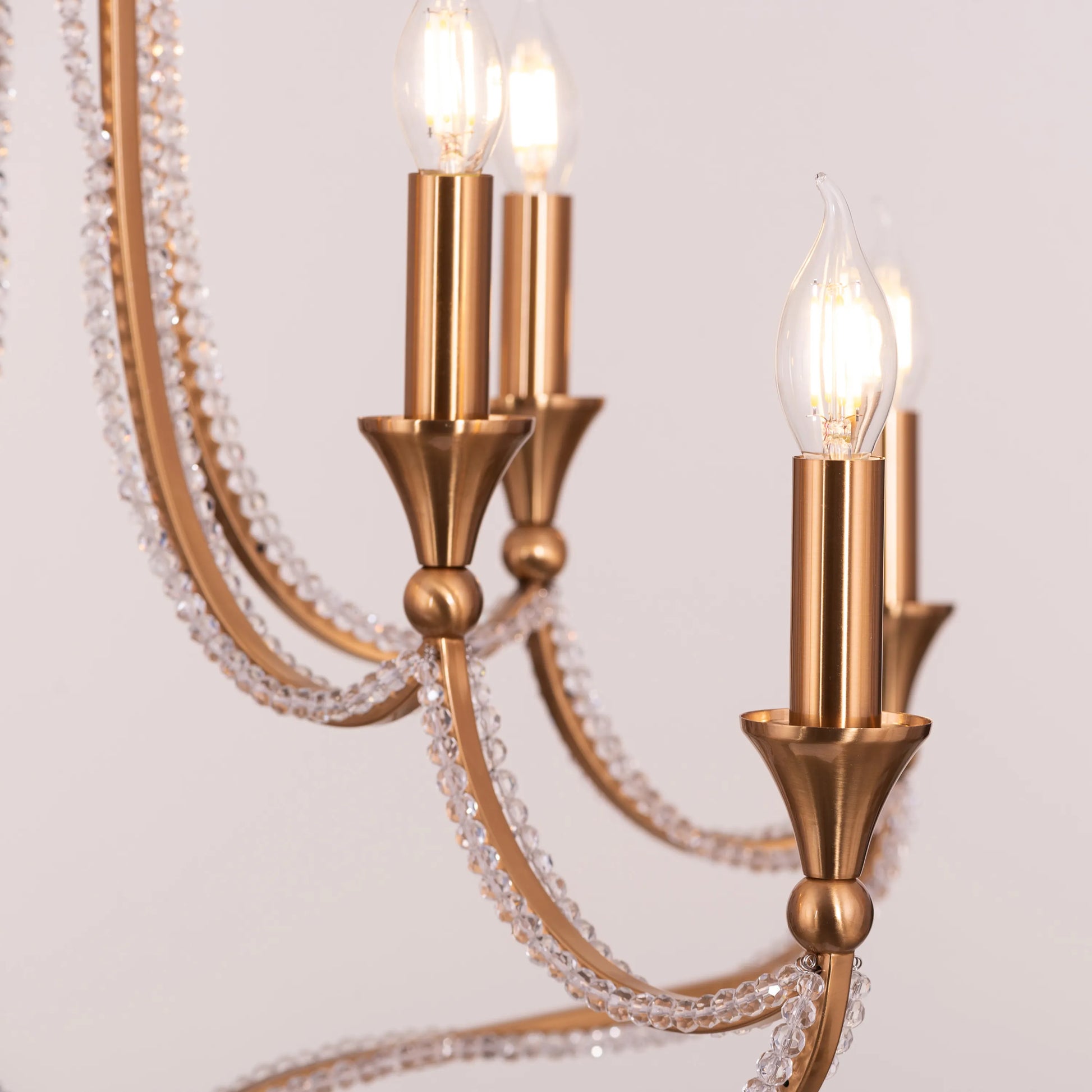 Large gold and crystal chandelier with cascading tiers resembling a fountain of light