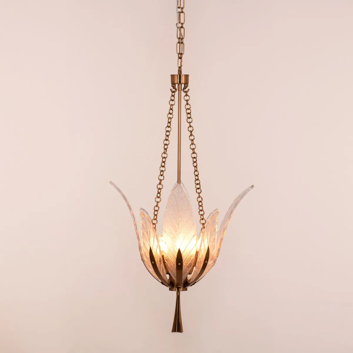 Trance Small Gold Glass Chandelier illuminating an intimate dining nook with warm, golden light