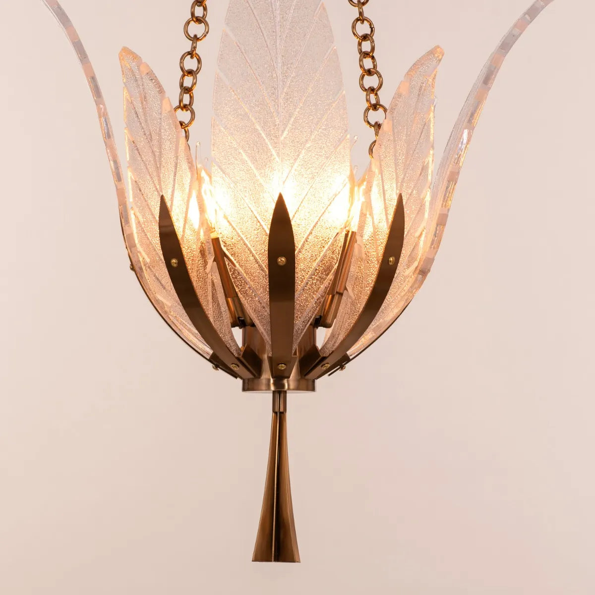 Trance Small Gold Glass Chandelier illuminating an intimate dining nook with warm, golden light