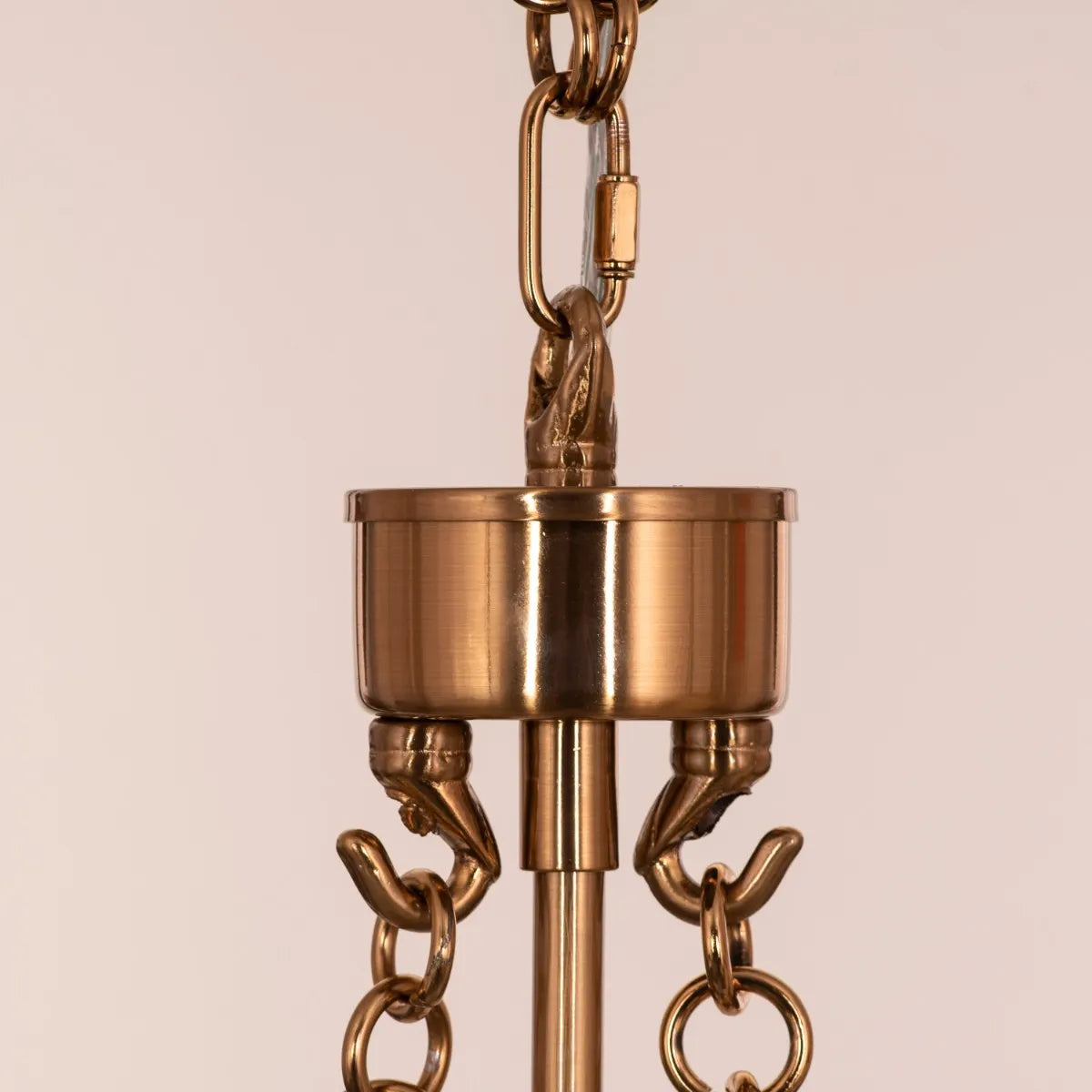 Trance Small Gold Glass Chandelier illuminating an intimate dining nook with warm, golden light