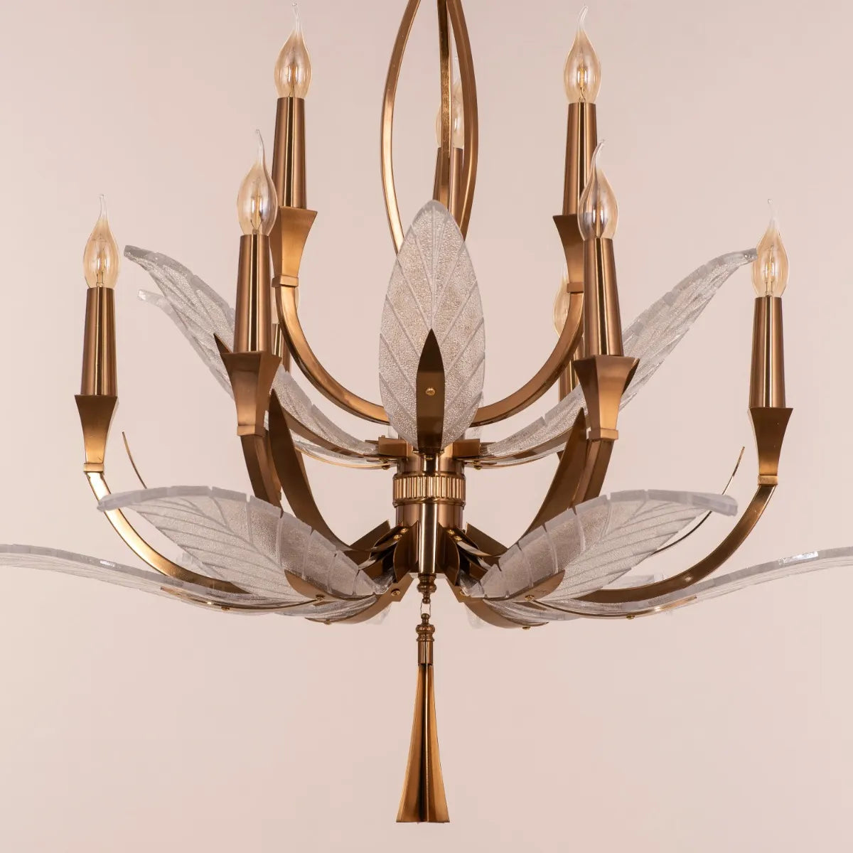 Medium-sized gold chandelier with unique glass elements, suspended in a contemporary living room