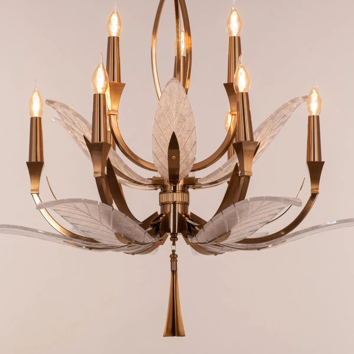 Medium-sized gold chandelier with unique glass elements, suspended in a contemporary living room