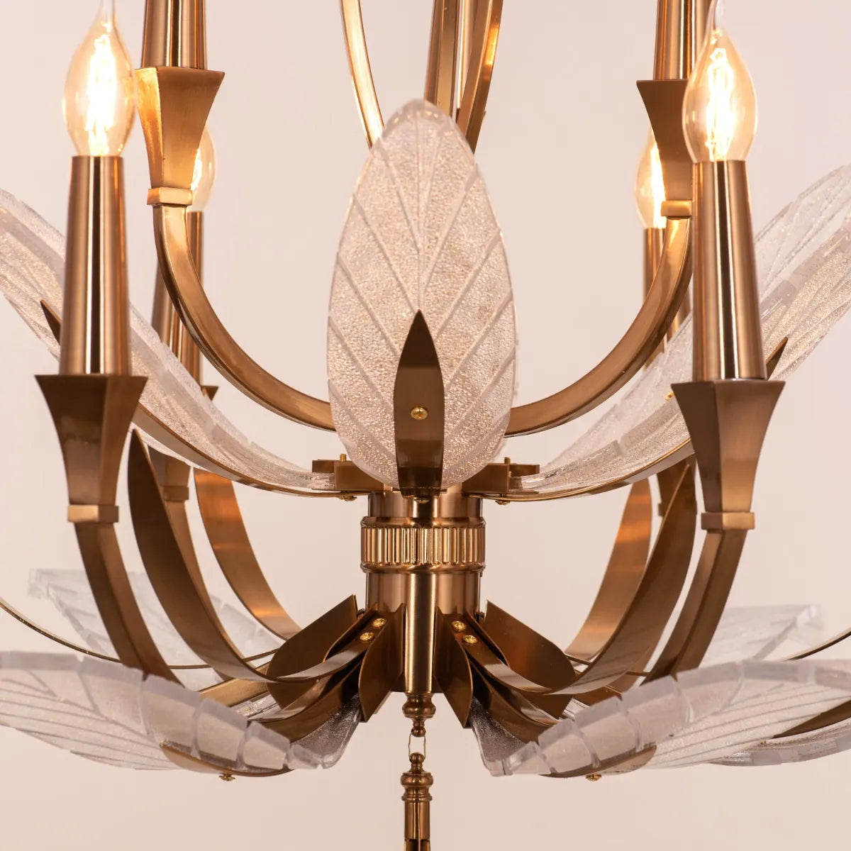 Medium-sized gold chandelier with unique glass elements, suspended in a contemporary living room