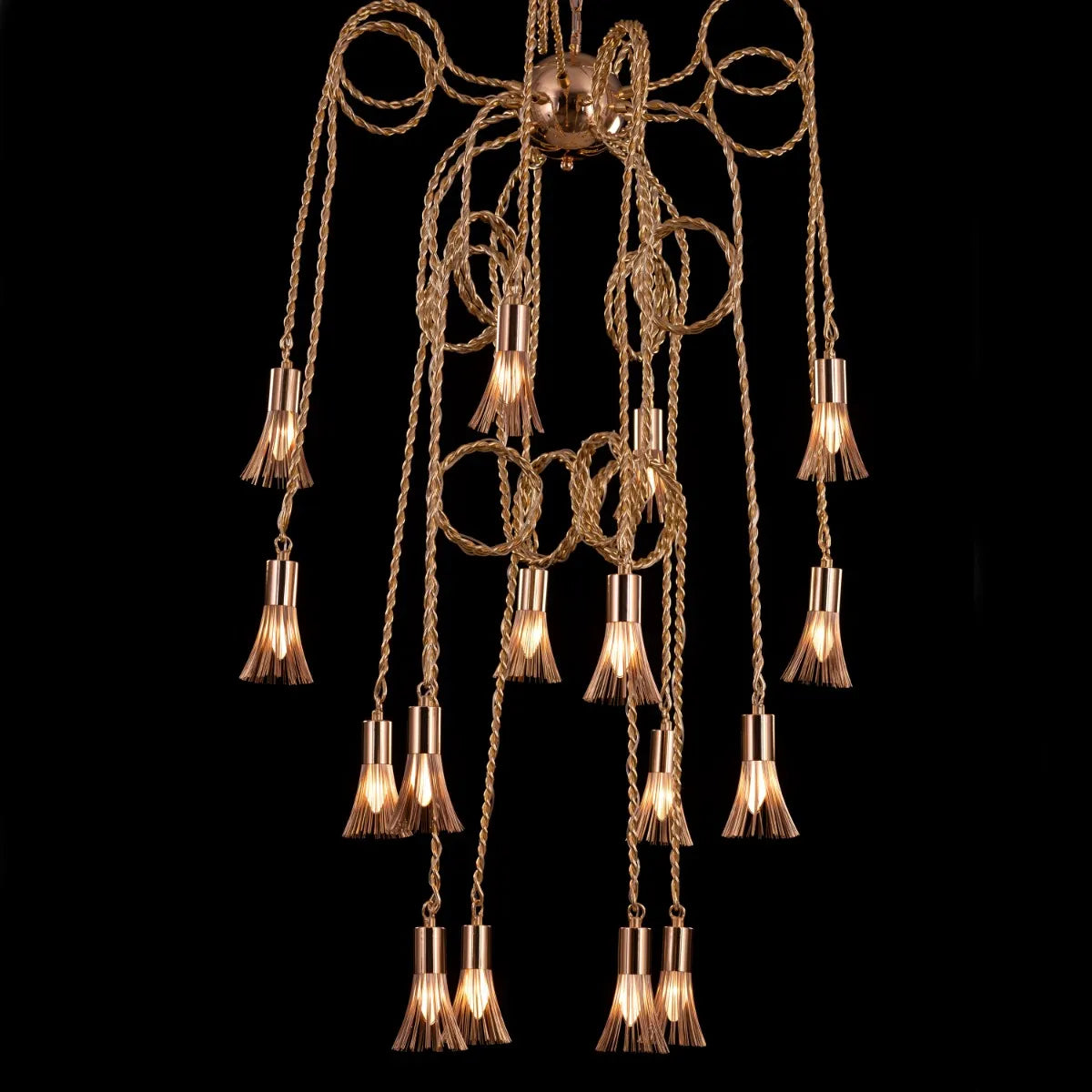 Wild Honey Chandelier with flowing golden arms illuminating a dining room.