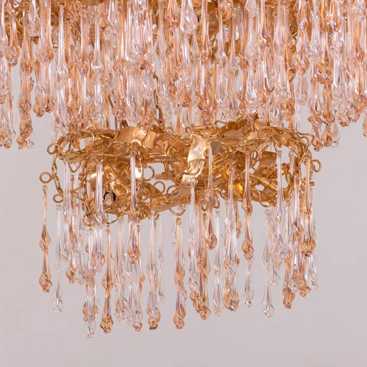 Medium-sized amber crystal chandelier with two layers resembling a golden galaxy