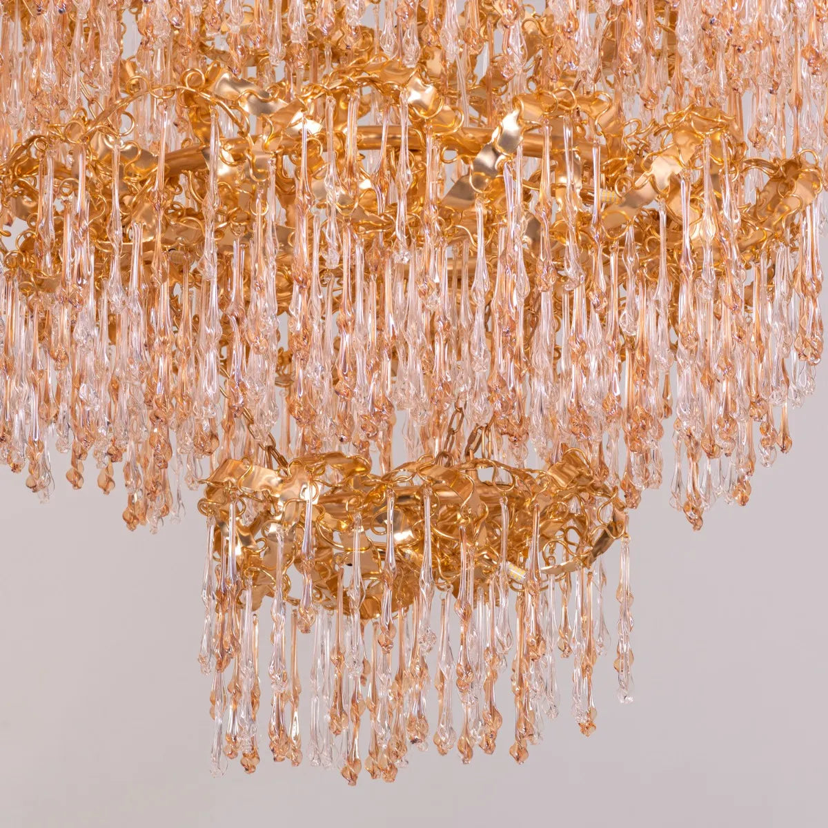 Large gold 3-layer crystal chandelier resembling a sparkling galaxy