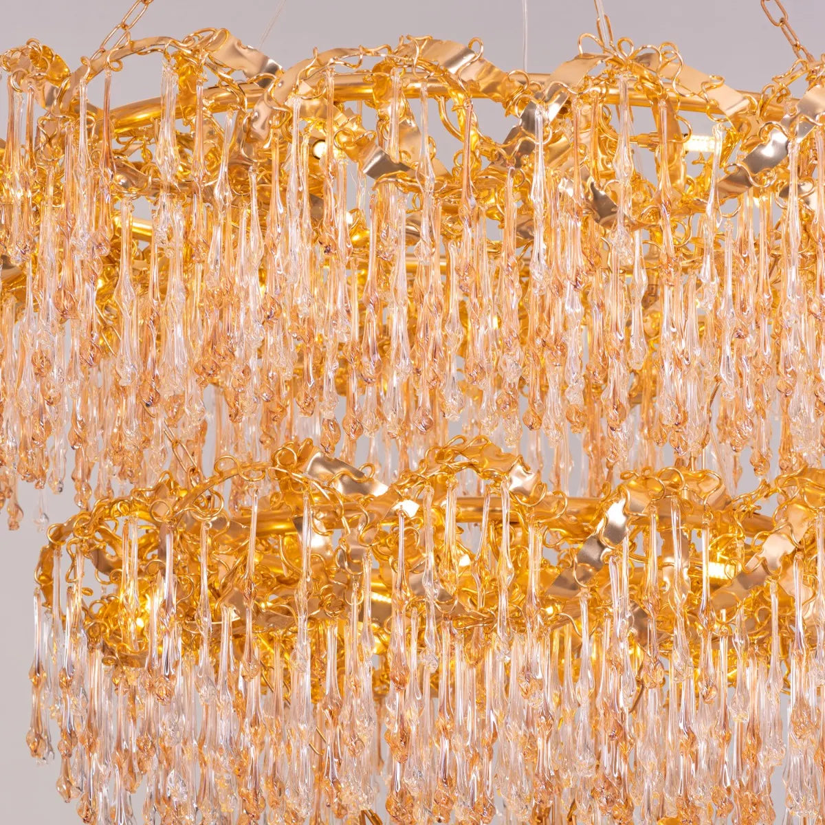 Large gold 3-layer crystal chandelier resembling a sparkling galaxy